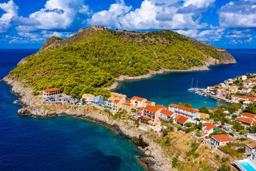 Assos village in Kefalonia, Greece. Turquoise colored bay in Mediterranean sea with beautiful colorful houses in Assos village in Kefalonia, Greece, Ionian island, Cephalonia, Assos village.