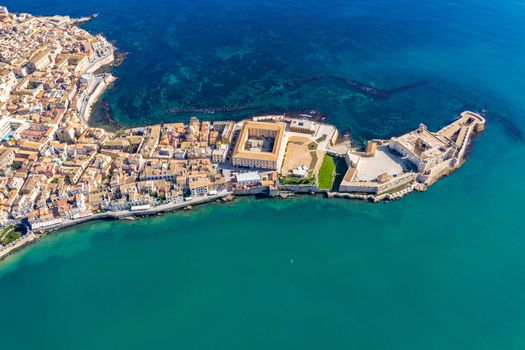 Siracusa, Ortigia Island from the air, Sicily, Italy. Isola di Ortigia, coast of Ortigia island at city of Syracuse, Sicily, Italy. Coastline town Syracuse, Sicily and old Ortigia island. Aerial view.