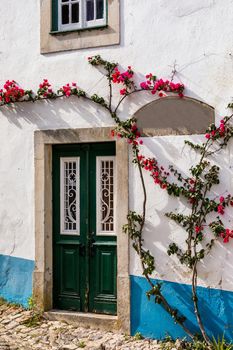 Historic walled town of Obidos, near Lisbon, Portugal. Beautiful streets of Obidos Medieval Town, Portugal. Street view of medieval fortress in Obidos. Portugal.