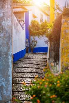 Historic walled town of Obidos, near Lisbon, Portugal. Beautiful streets of Obidos Medieval Town, Portugal. Street view of medieval fortress in Obidos. Portugal.