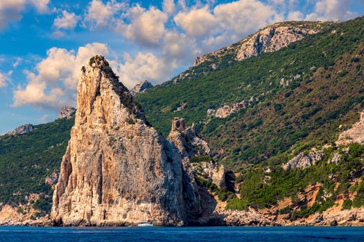 The monolith of Pedra Longa, Baunei, province of Ogliastra, East Sardinia, Italy. The rocky spire which rises majestically out of the sea. Holidays in Sardinia, Italy.