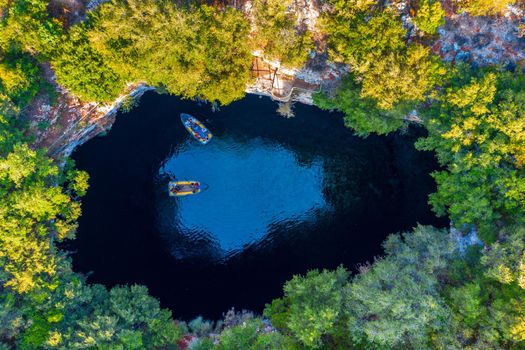 Melissani lake on Kefalonia island, Greece. Melissani Cave (Melissani Lake) near Sami village in Kefalonia island, Greece. Tourist boat on the lake in Melissani Cave, Kefalonia Island, Greece