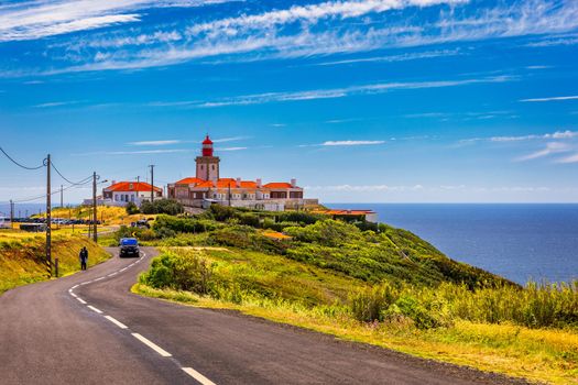 The lighthouse in Cabo da Roca. Cliffs and rocks on the Atlantic ocean coast in Sintra in a beautiful summer day, Portugal. Cabo da Roca, Portugal. Lighthouse and cliffs over Atlantic Ocean.