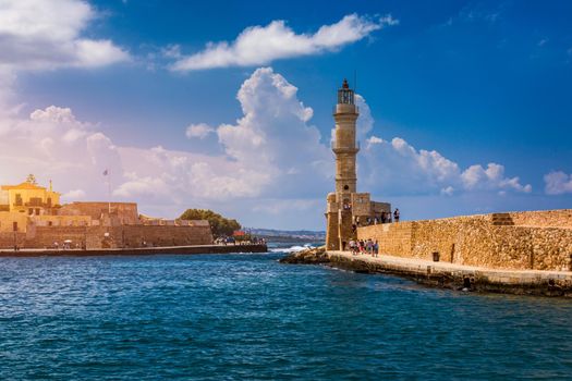 Panorama of venetian harbour waterfront and lighthouse in old harbour of Chania, Crete, Greece. Old venetian lighthouse in Chania, Greece. Lighthouse of the old Venetian port in Chania, Greece.