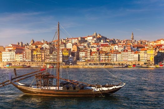 Port wine boats at the waterfront with the old town on the Douro River in Ribeira in the city centre of Porto in Porugal, Europe. Portugal, Porto