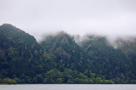 Azores panoramic view of natural landscape, wonderful scenic island of Portugal. Beautiful lagoons in volcanic craters and green fields. Tourist attraction and travel destination. Azores, Portugal.