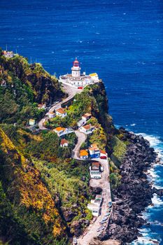Dramatic view down to lighthouse on Ponta do Arnel, Nordeste, Sao Miguel Island, Azores, Portugal. Lighthouse Arnel near Nordeste on Sao Miguel Island, Azores, Portugal. 
