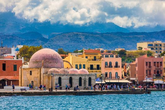 Mosque in the old Venetian harbor of Chania town on Crete island, Greece. Old mosque in Chania. Janissaries or Kioutsouk Hassan Mosque in Chania Crete. Turkish mosque in Chania bay. Crete, Greece.