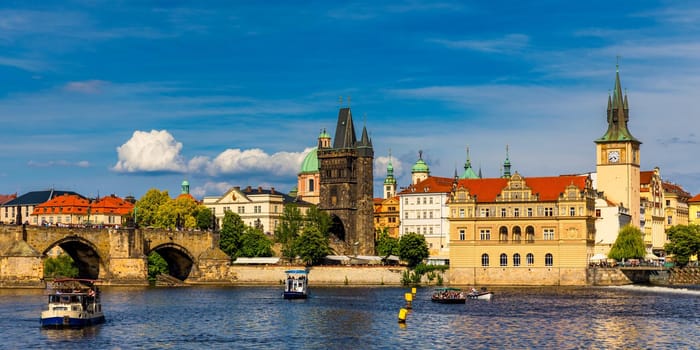 Prague in a sunny day, view of the old town, Prague, Czech Republic. Scenic summer view of the Old Town pier architecture and Charles Bridge over Vltava river in Prague, Czech Republic