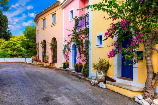 Assos village in Kefalonia, Greece. Turquoise colored bay in Mediterranean sea with beautiful colorful houses in Assos village in Kefalonia, Greece, Ionian island, Cephalonia, Assos village.