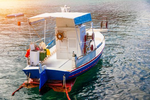 Vintage wooden boat in coral sea. Boat drone photo. Fishing boats in clear turquoise ocean, top view. Small fishing boat moored in blue clean transparent water. Aerial view. Peniche, Portugal.