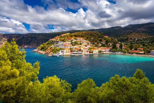 Assos village in Kefalonia, Greece. Turquoise colored bay in Mediterranean sea with beautiful colorful houses in Assos village in Kefalonia, Greece, Ionian island, Cephalonia, Assos village.