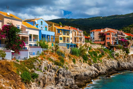Assos village in Kefalonia, Greece. Turquoise colored bay in Mediterranean sea with beautiful colorful houses in Assos village in Kefalonia, Greece, Ionian island, Cephalonia, Assos village.