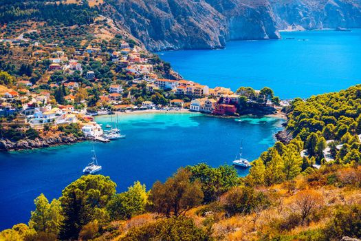 Assos village in Kefalonia, Greece. Turquoise colored bay in Mediterranean sea with beautiful colorful houses in Assos village in Kefalonia, Greece, Ionian island, Cephalonia, Assos village.