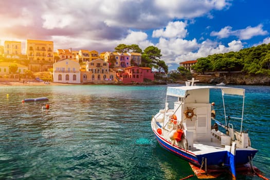 Turquoise colored bay in Mediterranean sea with beautiful colorful houses in Assos village in Kefalonia, Greece. Town of Assos with colorful houses on the mediterranean sea, Greece. 