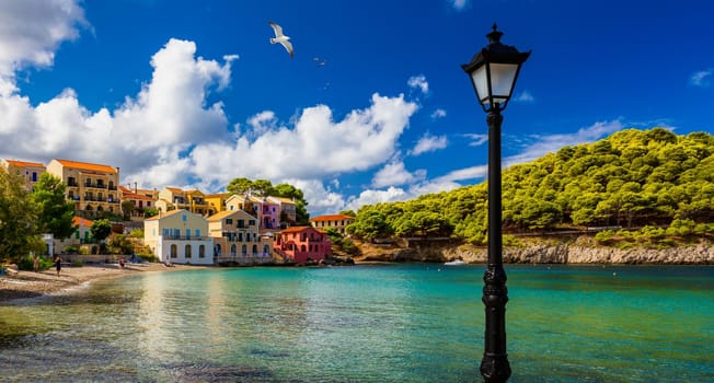 Assos village in Kefalonia, Greece. Turquoise colored bay in Mediterranean sea with beautiful colorful houses in Assos village in Kefalonia, Greece, Ionian island, Cephalonia, Assos village.