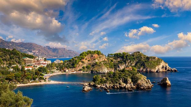 Aerial view of Isola Bella in Taormina, Sicily, Italy. Isola Bella is small island near Taormina, Sicily, Italy. Narrow path connects island to mainland Taormina beach in azure waters of Ionian Sea. 