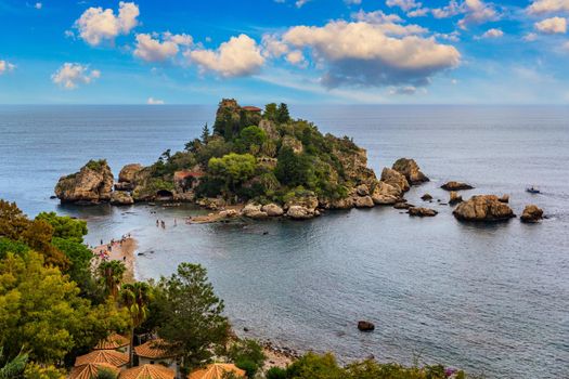 Aerial view of Isola Bella in Taormina, Sicily, Italy. Isola Bella is small island near Taormina, Sicily, Italy. Narrow path connects island to mainland Taormina beach in azure waters of Ionian Sea. 