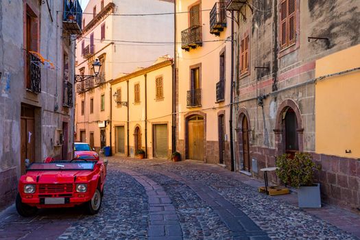 Street view of the beautiful village of Bosa with colored houses and a medieval castle. Bosa is located in the north-wesh of Sardinia, Italy. Street view of colorful houses in Bosa village, Sardegna.