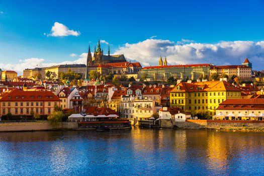 Prague Castle, Charles Bridge and boats on the Vltava river. View of Hradcany Prague Castle, Charles Bridge and a boats on the Vltava river in the capital of the Czechia. Boat cruise on Vltava river.