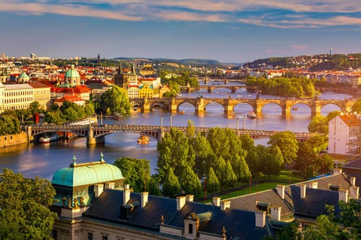 Scenic view of the Old Town pier architecture and Charles Bridge over Vltava river in Prague, Czech Republic. Prague iconic Charles Bridge (Karluv Most) and Old Town Bridge Tower at sunset, Czechia.