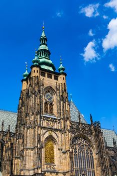 Prague, bell gothic towers and St. Vitus Cathedral. St. Vitus is a Roman Catholic cathedral in Prague, Czech Republic. Panoramic view from the courtyard to the south facade. Prague, Czechia.