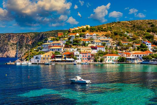 Assos village in Kefalonia, Greece. Turquoise colored bay in Mediterranean sea with beautiful colorful houses in Assos village in Kefalonia, Greece, Ionian island, Cephalonia, Assos village.