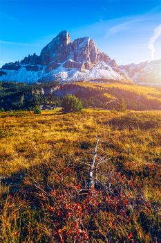 Stunning view of Peitlerkofel mountain from Passo delle Erbe in Dolomites, Italy. View of Sass de Putia (Peitlerkofel) at Passo delle Erbe, with wooden farm houses, Dolomites, South Tyrol, Italy.