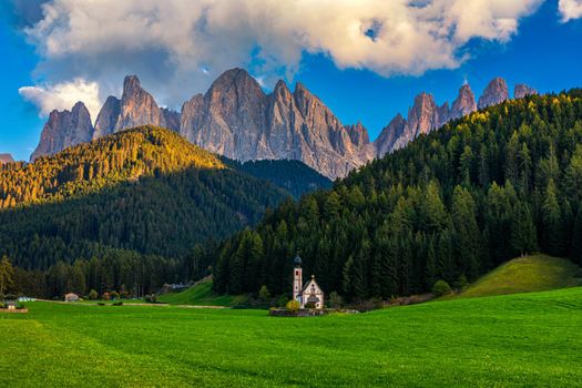 Landscapes with San Giovanni Church and small village in Val di Funes, Dolomite Alps, South Tyrol, Italy, Europe. San Giovanni in Ranui church (St John in Ranui church) in the Dolomites, Italy.