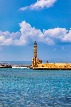 Panorama of venetian harbour waterfront and lighthouse in old harbour of Chania, Crete, Greece. Old venetian lighthouse in Chania, Greece. Lighthouse of the old Venetian port in Chania, Greece.