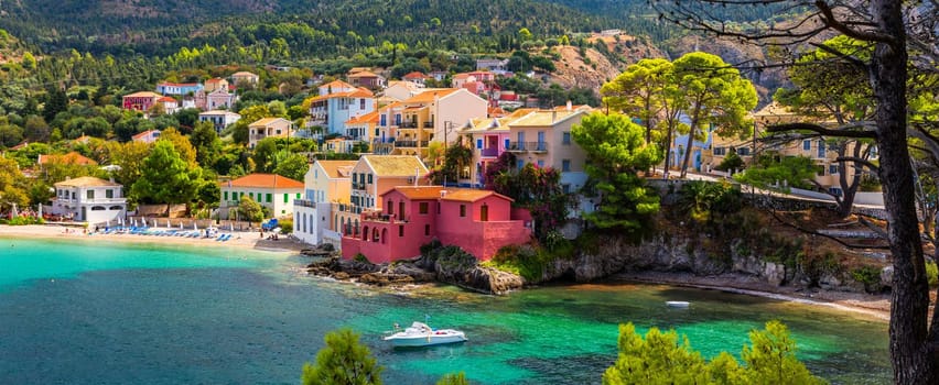 Assos village in Kefalonia, Greece. Turquoise colored bay in Mediterranean sea with beautiful colorful houses in Assos village in Kefalonia, Greece, Ionian island, Cephalonia, Assos village.