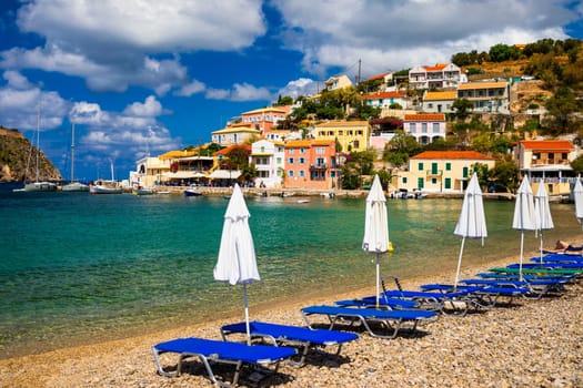 Assos village in Kefalonia, Greece. Turquoise colored bay in Mediterranean sea with beautiful colorful houses in Assos village in Kefalonia, Greece, Ionian island, Cephalonia, Assos village.