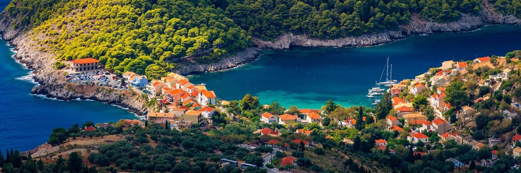 Assos village in Kefalonia, Greece. Turquoise colored bay in Mediterranean sea with beautiful colorful houses in Assos village in Kefalonia, Greece, Ionian island, Cephalonia, Assos village.