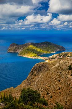 Assos village in Kefalonia, Greece. Turquoise colored bay in Mediterranean sea with beautiful colorful houses in Assos village in Kefalonia, Greece, Ionian island, Cephalonia, Assos village.