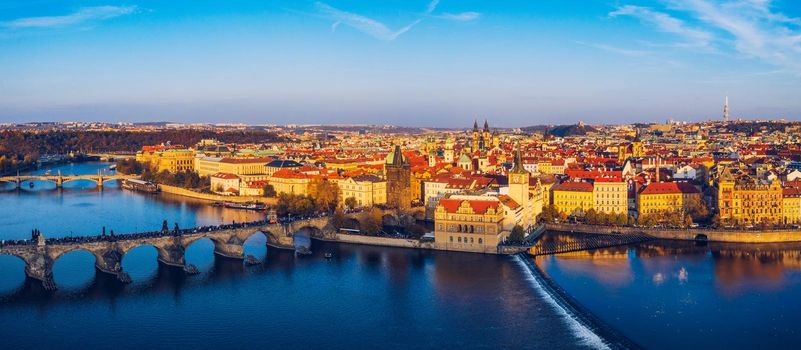 Aerial Prague panoramic drone view of the city of Prague at the Old Town Square, Czechia. Prague Old Town pier architecture and Charles Bridge over Vltava river in Prague at sunset, Czech Republic. 