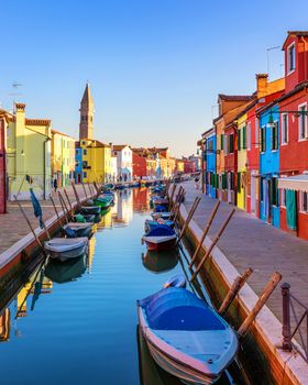 Street with colorful buildings in Burano island, Venice, Italy. Architecture and landmarks of Burano, Venice postcard. Scenic canal and colorful architecture in Burano island near Venice, Italy