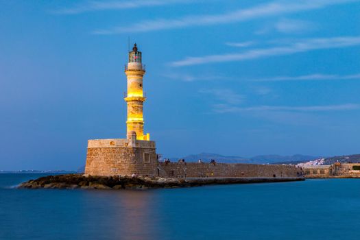 Venetian harbour and lighthouse in old harbour of Chania at sunset, Crete, Greece. Old venetian lighthouse in Chania, Greece. Lighthouse of the old Venetian port in Chania, Greece.