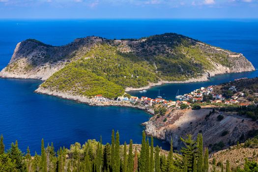 Assos village in Kefalonia, Greece. Turquoise colored bay in Mediterranean sea with beautiful colorful houses in Assos village in Kefalonia, Greece, Ionian island, Cephalonia, Assos village.