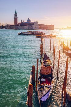 Gondolas moored near San Marco square across from San Giorgio Maggiore island in Venice, Italy. Gondolas were once the main form of transportation around the Venetian canals. Venice, Italy.