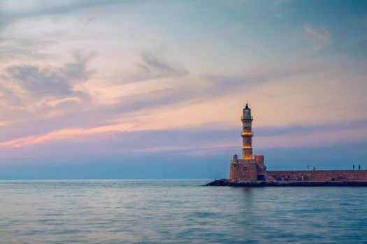 Panorama of venetian harbour waterfront and lighthouse in old harbour of Chania, Crete, Greece. Old venetian lighthouse in Chania, Greece. Lighthouse of the old Venetian port in Chania, Greece.