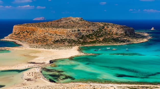 Fantastic panorama of Balos Lagoon and Gramvousa island on Crete, Greece. Cap tigani in the center. Balos beach on Crete island, Greece. Tourists relax and bath in crystal clear water of Balos beach.