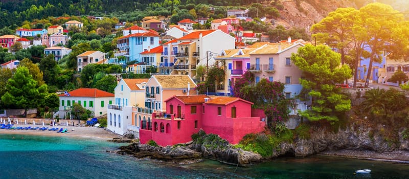 Assos village in Kefalonia, Greece. Turquoise colored bay in Mediterranean sea with beautiful colorful houses in Assos village in Kefalonia, Greece, Ionian island, Cephalonia, Assos village.