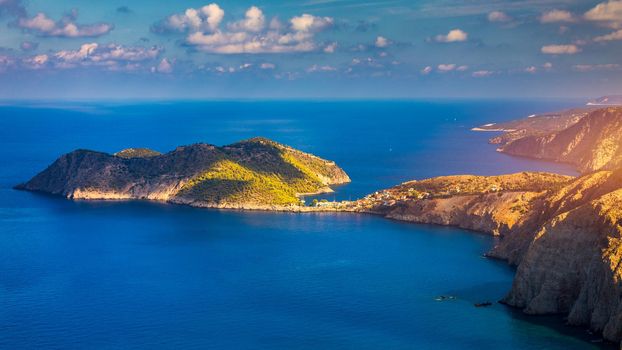 Aerial drone view video of beautiful and picturesque colorful traditional fishing village of Assos in island of Cefalonia, Ionian, Greece. Peninsula of Assos in Cephalonia (Kefalonia), Greece