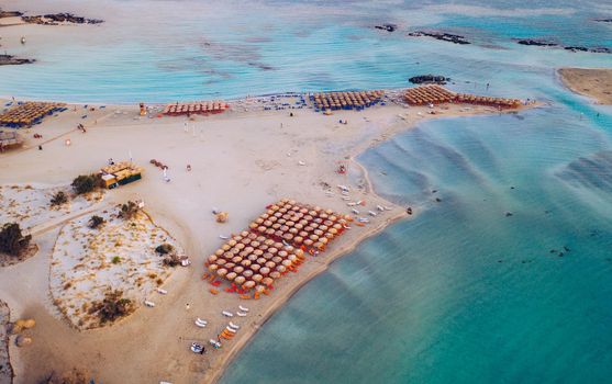 Aerial drone shot of beautiful turquoise beach with pink sand Elafonissi, Crete, Greece. Best beaches of Mediterranean, Elafonissi beach, Crete, Greece. Famous Elafonisi beach on Greece island, Crete.