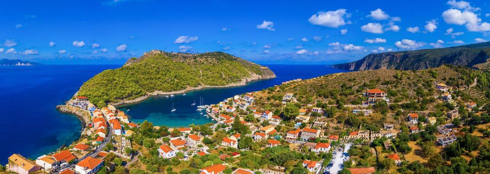 Aerial drone view video of beautiful and picturesque colorful traditional fishing village of Assos in island of Cefalonia, Ionian, Greece. Peninsula of Assos in Cephalonia (Kefalonia), Greece