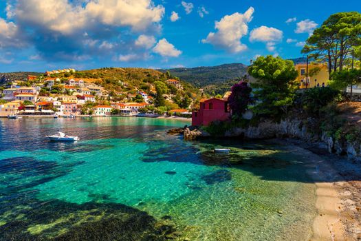 Assos village in Kefalonia, Greece. Turquoise colored bay in Mediterranean sea with beautiful colorful houses in Assos village in Kefalonia, Greece, Ionian island, Cephalonia, Assos village.