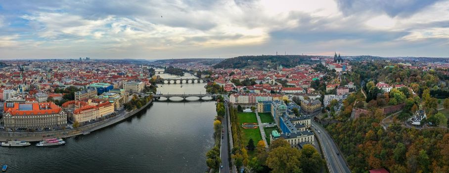 Aerial Prague panoramic drone view of the city of Prague at the Old Town Square, Czechia. Prague Old Town pier architecture and Charles Bridge over Vltava river in Prague at sunset, Czech Republic. 