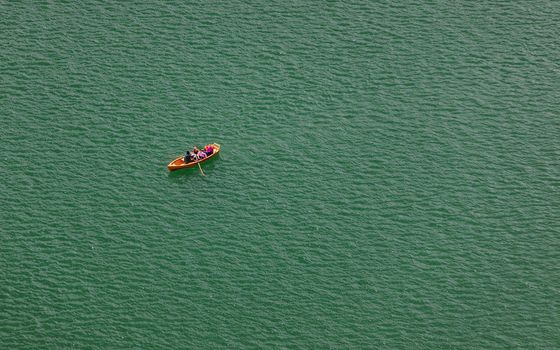 Lake Bled, Slovenia. Top view of a boat sailing in the lake. Bled lake is the most famous lake in Slovenia. Bled, Slovenia.