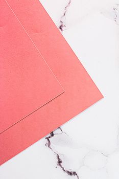 Pink A4 papers on white marble background as office stationery flatlay, luxury branding flat lay and brand identity design for mockups