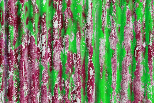 colorful motley peeled off red and greenpaint layers on corrugated zinc coated steel sheet - full frame background and texture